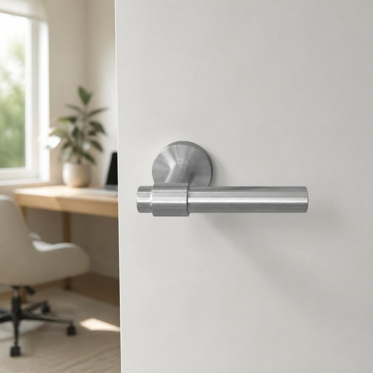 Brushed stainless steel lever handle on round rose