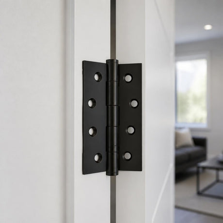 Matt black butt hinge 100x75mm on a white interior door