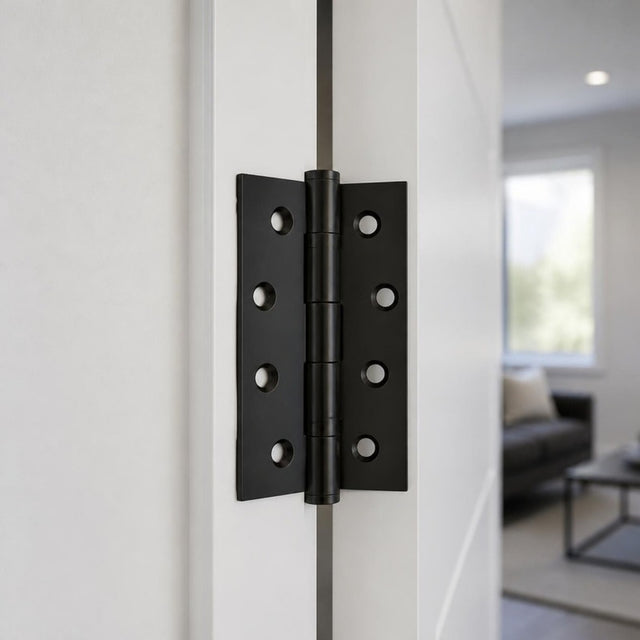 Matt black butt hinge 100x75mm on a white interior door